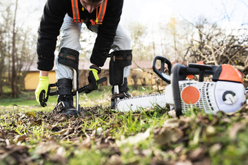 Sticker - Lumberjack putting on a harness going to prune a tree.