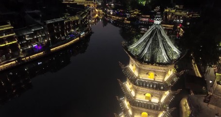 Poster - Fenghuang Ancient Town. Located in Fenghuang County. Southwest of HuNan Province, China. View of illuminated riverside houses.