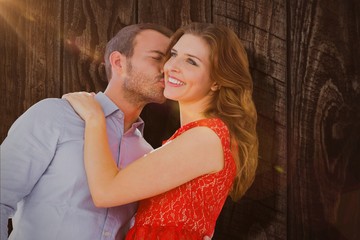 Wall Mural - Composite image of man kissing woman on cheek