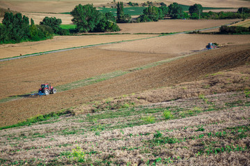 Tractor plowing field