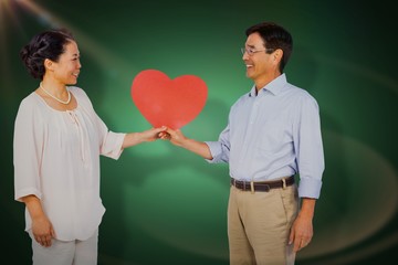 Poster - Composite image of older asian couple holding heart