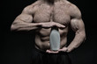 sexy muscular male torso of athlete man holds drink bottle