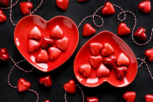 Valentine's Dessert, Chocolates In The Shape Of Hearts On Black Background, Top View