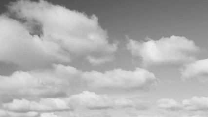 Wall Mural - fluffy clouds move across the sky in this thirty second looping video with a gray tones.