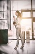 © vectorfusionart - Businesswoman holding digital tablet and mobile phone