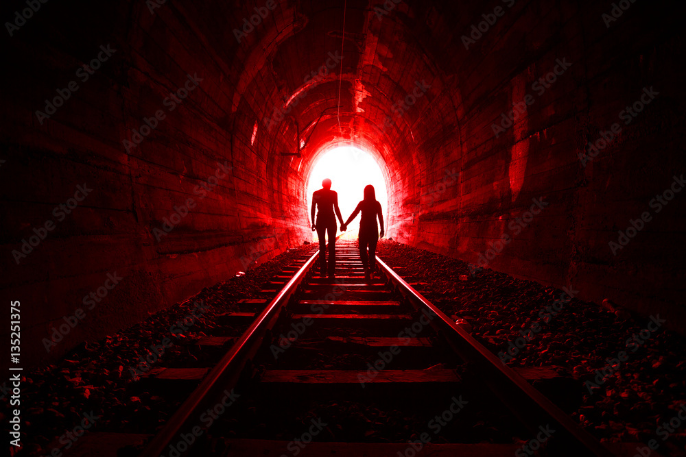 Couple in love walking together through a railway tunnel Stock Photo ...