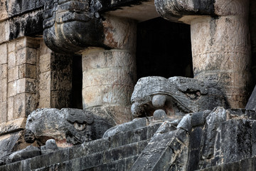 Wall Mural - The upper level of the Temple of the Jaguars with the carved heads of Kukulcan, facing the great Ball Court in Chichen Itza, Yucatan, Mexico.