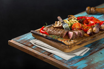 Poster - Sliced steak grill with grilled vegetables on the wooden table