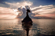 © zolotareva_elina - Elegant woman dancing on water. Sunset and silhouette.