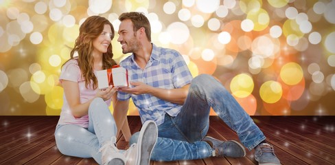 Poster - Composite image of happy man giving gift to woman