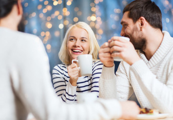 Canvas Print - happy friends meeting and drinking tea or coffee