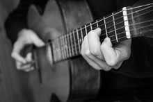 Man Playing Classical Guitar. Black And White Photo.