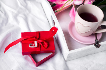 Wall Mural - tray with cup of hot tea in the bed,