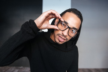 Portrait of handsome african young man in hoodie and glasses