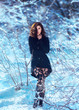 © kharchenkoirina - Beautiful brunette girl is walking in the winter forest.