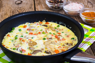 Wall Mural - Omelet with vegetables in a pan