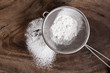 Wheat flour in a sieve on wooden background,food ingredient,prepare for cooking or baking