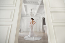 Beautiful Bride Posing In Wedding Dress In A White Photo Studio.
