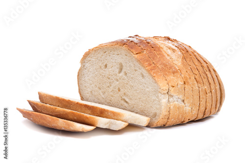 Fotografie, Obraz Sliced crusty country style round organic french bread isolated on white backgro