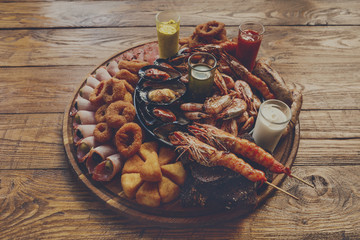 Wall Mural - Seafood platter on wooden table background