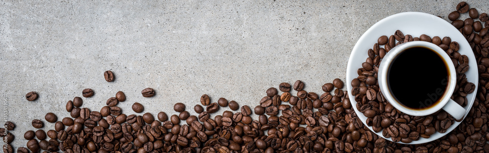 Cup of coffee with coffee beans on gray stone background. Top view - obrazy, fototapety, plakaty 