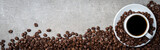 Fototapeta Kawa jest smaczna - Cup of coffee with coffee beans on gray stone background. Top view