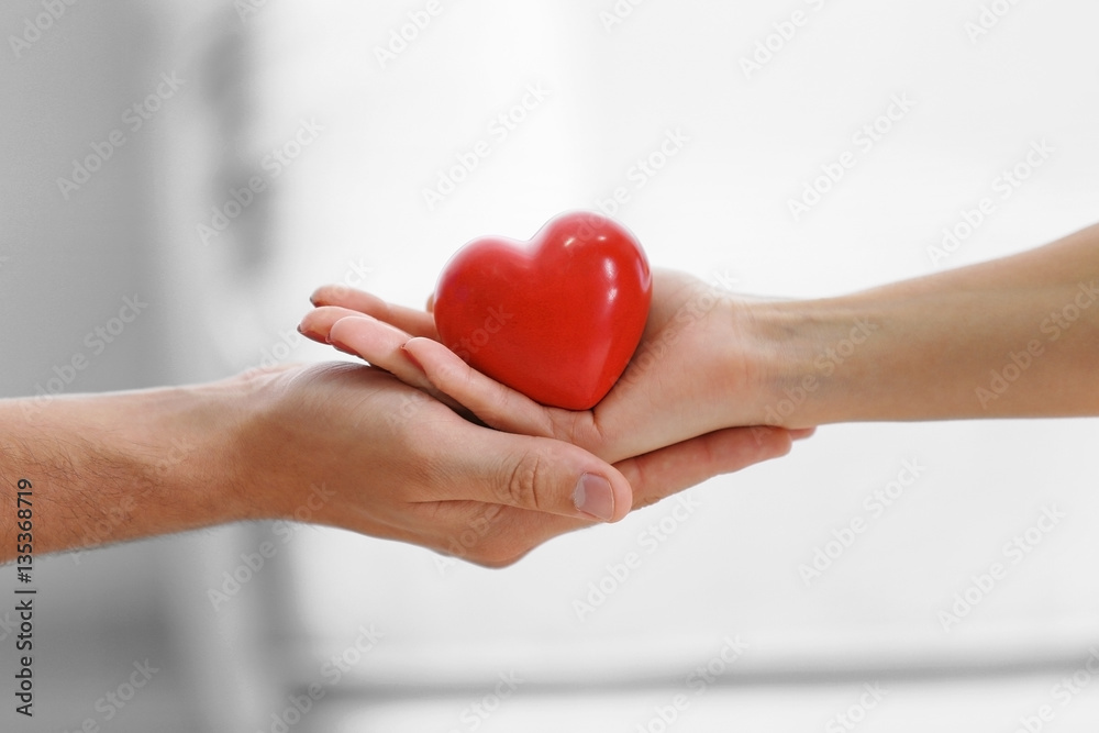 Couple hands with red heart, closeup