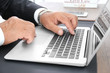 © Africa Studio - Male lawyer working with laptop in office, close up view