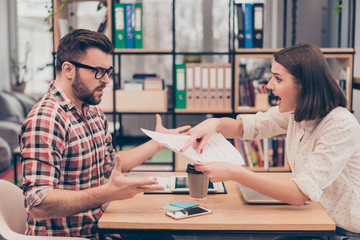 Young frustrated woman yelling and screaming on her colleague