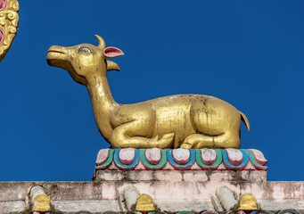 TENGBOCHE, NEPAL - OCTOBER 30: The sculpture of the wheel of Dharma and two deer on the roof of the gate. Festival of Tengboche Monastery. Khumbu region on October 30, 2012 in Tengboche