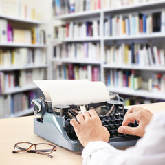 Poster - Man working on retro typewriter at desk in library