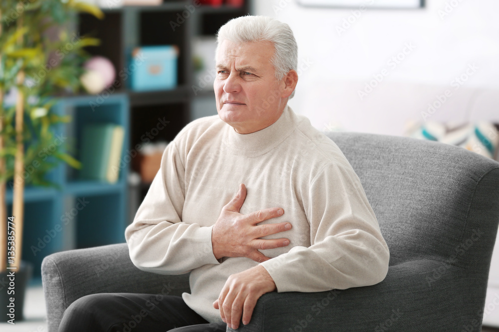 Aged man having heart pain, at home
