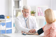 © Africa Studio - Doctor measuring blood pressure of patient