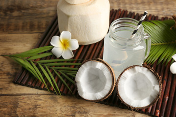 Poster - Fresh nuts and mason jar with coconut water on bamboo mat