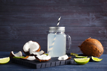 Wall Mural - Fresh nuts and mason jar with coconut water on wooden background