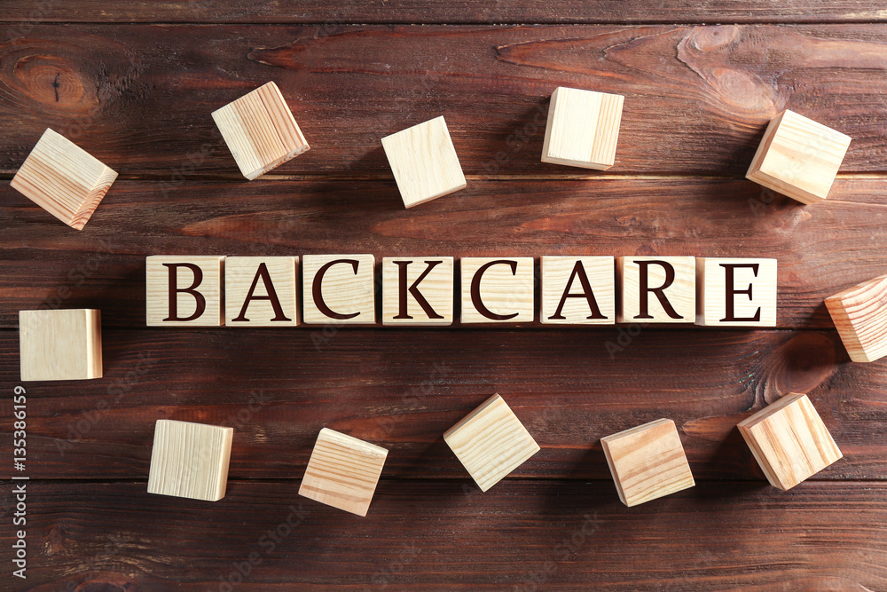 Cubes with word POSTURE on brown wooden background