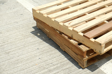 Two old pallets on the floor with space