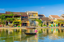 Woman Crossing A River On A Boat In Hoi An During Mid Day