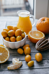 Wall Mural - Harvest of citrus: Kumquat, oranges, lemons and fresh juice sque