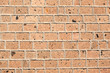 A brick wall built of bricks of the Armenian tuff