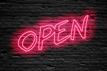 OPEN. Fluorescent Neon Tube Sign On Dark Brick Wall. Front View. Can Be Used For Online Banner Ads Or Background. Night Moment.