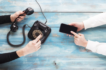 Wall Mural - Old and new phone. Concept of technology progress