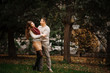 © AS Photo Family - Young couple wearing on tied warm sweaters hugging in love at ci