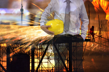  Construction safety concept , engineer  holding yellow helmet and blur construction background .