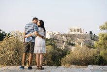 Greece, Athens, Couple Kissing At Areopagus With The Acropolis And Parthenon In The Background