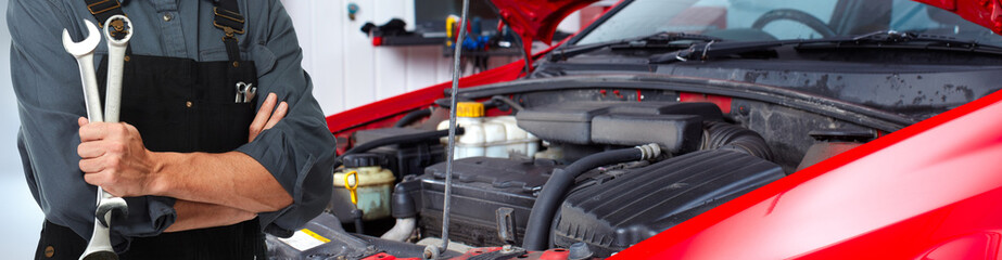 Hands of car mechanic with wrench