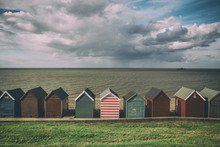 Row Of Beach Huts Of Cloudy Day With Rain Clouds In Kent, England