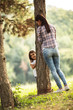 © BalanceFormCreative - Mother and daughter play hide and seek at the park.