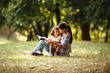 © BalanceFormCreative - Mother and daughter relaxing in park.She reading a fairytale to her daughter