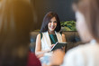 © stnazkul - Pretty girl using tablet in coffee shop meeting with friends